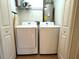 Convenient laundry room with a washer, dryer, and overhead storage at 7411 S Elliott St, Tampa, FL 33616