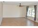 Open living room area with tile flooring, neutral walls, and natural light from a large window at 7411 S Elliott St, Tampa, FL 33616