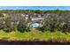 Aerial view of a neighborhood with lush greenery surrounding homes and a view of a pool and waterway at 7425 Terrace River Dr, Temple Terrace, FL 33637