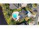 Overhead aerial view of a house with a pool and a rooftop terrace, adjacent to a lakeside property at 7425 Terrace River Dr, Temple Terrace, FL 33637