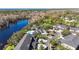 Scenic aerial view of community with pool, lake, lush landscaping and well-maintained building exteriors at 7425 Terrace River Dr, Temple Terrace, FL 33637