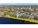 Extensive aerial view featuring neighborhood homes near a lake, surrounded by lush greenery and mature trees at 7425 Terrace River Dr, Temple Terrace, FL 33637