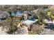 Stunning aerial view of a unique home with a rooftop terrace, a garage, and lush greenery at 7425 Terrace River Dr, Temple Terrace, FL 33637