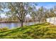 Serene backyard with lush greenery and waterfront views, ideal for outdoor enjoyment and relaxation at 7425 Terrace River Dr, Temple Terrace, FL 33637