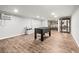 Spacious finished basement provides a versatile living area, complete with custom-tiled floors and foosball table at 7425 Terrace River Dr, Temple Terrace, FL 33637