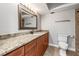 Bathroom showcasing granite countertops, wood cabinets, and a framed mirror at 7425 Terrace River Dr, Temple Terrace, FL 33637
