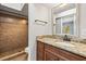 Bathroom with granite countertop vanity and tiled shower at 7425 Terrace River Dr, Temple Terrace, FL 33637