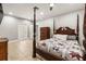 Spacious bedroom featuring tile flooring, ceiling fan, and an ornate four-poster bed at 7425 Terrace River Dr, Temple Terrace, FL 33637