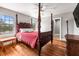Bedroom featuring hardwood floors, bed, and windows with view of foliage at 7425 Terrace River Dr, Temple Terrace, FL 33637