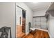 View into closet, with chair and dresser with TV visible in background at 7425 Terrace River Dr, Temple Terrace, FL 33637