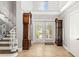 Grand foyer with soaring ceilings, staircase, and tile flooring at 7425 Terrace River Dr, Temple Terrace, FL 33637