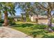 Charming front exterior view of the home showing the manicured lawn and front entrance at 7425 Terrace River Dr, Temple Terrace, FL 33637
