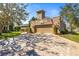 Exterior shot of the garage with long driveway at 7425 Terrace River Dr, Temple Terrace, FL 33637