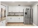 Bright kitchen with white cabinetry, granite countertops, and stainless steel refrigerator at 7425 Terrace River Dr, Temple Terrace, FL 33637