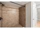 Tiled shower featuring bronze fixtures, a shower curtain rod, and small shower tiles at 7425 Terrace River Dr, Temple Terrace, FL 33637