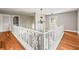Upstairs hallway with wooden floors at 7425 Terrace River Dr, Temple Terrace, FL 33637