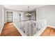 Upstairs hallway with hardwood floors and ornate railings at 7425 Terrace River Dr, Temple Terrace, FL 33637