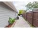 Paver patio along a gray house with a privacy fence and landscaping at 800 51St S St, Gulfport, FL 33707