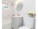 Modern bathroom featuring a marble tiled wall, a shower, and a round mirror at 800 51St S St, Gulfport, FL 33707