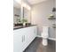 Modern bathroom featuring double vanity, granite countertops, and decorative shelves at 800 51St S St, Gulfport, FL 33707