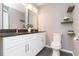 Modern bathroom featuring double vanity, granite countertops, and decorative shelves at 800 51St S St, Gulfport, FL 33707