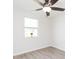 Bedroom featuring a ceiling fan, window, light wood flooring, and white walls at 800 51St S St, Gulfport, FL 33707