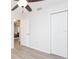 Bright bedroom featuring a ceiling fan, wood-look floors, and white closet doors at 800 51St S St, Gulfport, FL 33707