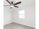 Bedroom featuring a ceiling fan, window overlooking the yard, and light wood flooring at 800 51St S St, Gulfport, FL 33707