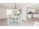 Open concept dining area with a view of the kitchen, a table, and seating for four at 800 51St S St, Gulfport, FL 33707