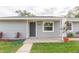 Close-up of a home entrance with fresh gray paint and a tidy walkway at 800 51St S St, Gulfport, FL 33707