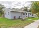 Attractive gray home with a neatly landscaped front yard at 800 51St S St, Gulfport, FL 33707
