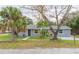 Charming gray home with a well-maintained lawn and mature trees at 800 51St S St, Gulfport, FL 33707