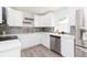 Modern kitchen featuring stainless steel appliances, white countertops, and backsplash at 800 51St S St, Gulfport, FL 33707