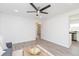Open living room with gray wood flooring, a ceiling fan, and plenty of natural light at 800 51St S St, Gulfport, FL 33707