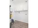 A bright utility room with a modern water heater, white cabinets, and vinyl flooring at 800 51St S St, Gulfport, FL 33707
