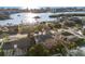 An aerial view of a single Gathering neighborhood close to the water featuring well maintained lawns and mature trees at 8083 Bayhaven Dr, Seminole, FL 33776