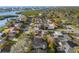 This aerial view of the neighborhood reveals meticulously kept residences and community features like swimming pools and solar panels at 8083 Bayhaven Dr, Seminole, FL 33776
