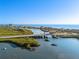 Breathtaking aerial view of a coastal community, showcasing the bridge, intercoastal waterway, and scenic waterfront homes at 8083 Bayhaven Dr, Seminole, FL 33776