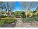 Serene backyard retreat featuring a charming garden swing and lush landscaping at 8083 Bayhaven Dr, Seminole, FL 33776