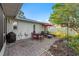 Patio area in a beautifully landscaped backyard with space for dining and relaxation at 8083 Bayhaven Dr, Seminole, FL 33776