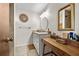 Bathroom featuring a walk-in shower, vanity with sink and decorative fixtures at 8083 Bayhaven Dr, Seminole, FL 33776