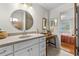 Bathroom with tiled floors, vanity with sink, a large mirror and access to the bedroom at 8083 Bayhaven Dr, Seminole, FL 33776