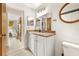 Bathroom vanity with a decorative mirror and a glimpse of an adjacent bedroom at 8083 Bayhaven Dr, Seminole, FL 33776