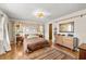 Bright bedroom with wood floors, decorative headboard, and natural lighting at 8083 Bayhaven Dr, Seminole, FL 33776