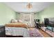 Comfortable bedroom featuring neutral tones, ceiling fan, hardwood floors, and an efficient workspace setup at 8083 Bayhaven Dr, Seminole, FL 33776