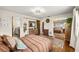 Bedroom view highlighting wood floors, mirrored closet, and access to the kitchen at 8083 Bayhaven Dr, Seminole, FL 33776
