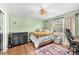 Cozy bedroom with a bed, wood floors, and a ceiling fan at 8083 Bayhaven Dr, Seminole, FL 33776