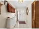 Welcoming entryway with a white door, decorative mirror, and storage cabinet at 8083 Bayhaven Dr, Seminole, FL 33776