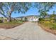Charming single-story home with an attached two-car garage, mature trees, and a well-manicured front yard at 8083 Bayhaven Dr, Seminole, FL 33776