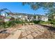 Inviting home exterior with a white facade, lush landscaping, and a sitting area outside the two-car garage at 8083 Bayhaven Dr, Seminole, FL 33776